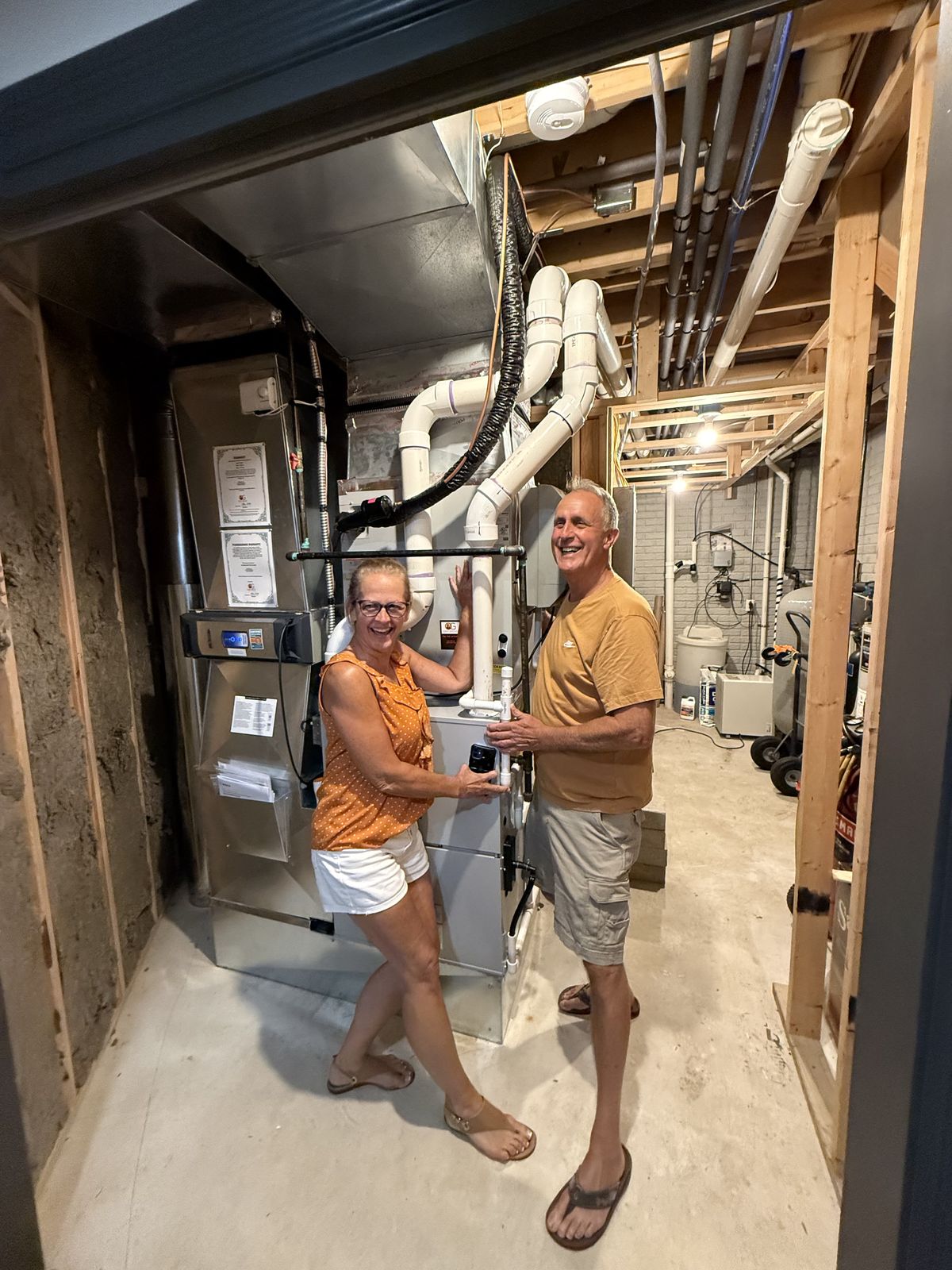 Happy Oak Grove customers next to their newly installed furnace