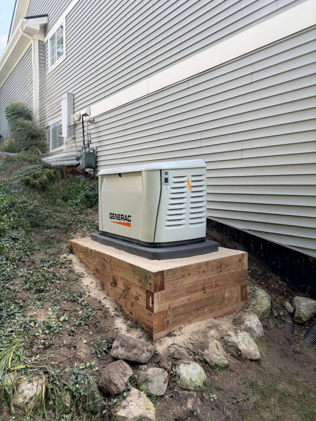 A Generac standby generator installed by Oak Grove beside a Michigan home